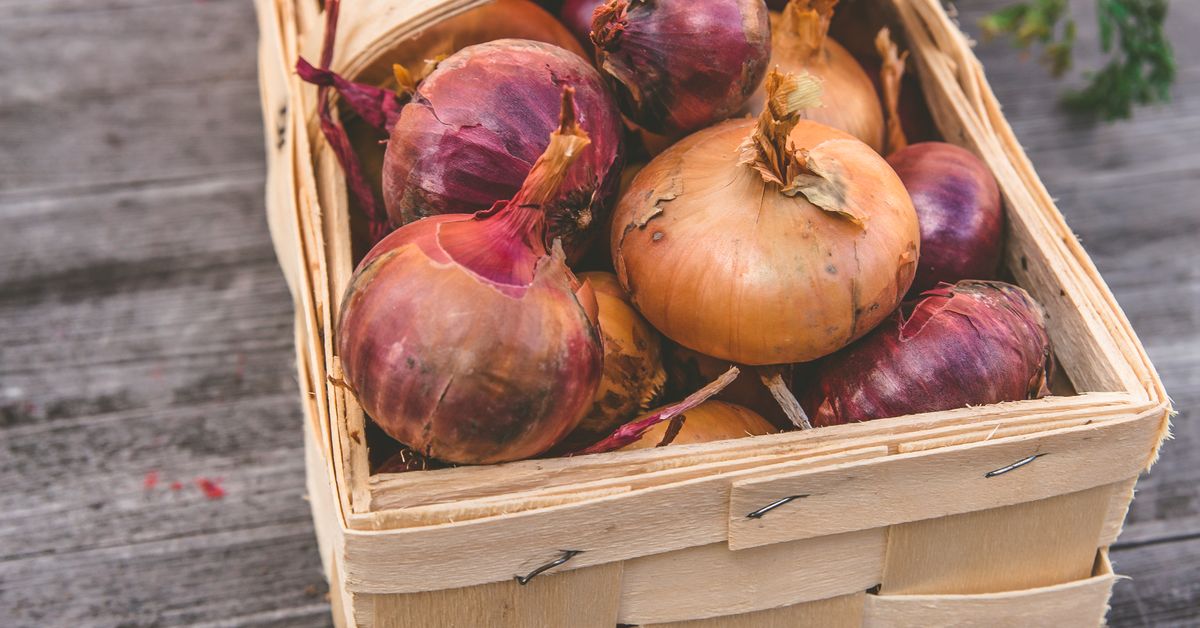 Basket of fresh onions and carrots, onion price today in mandis