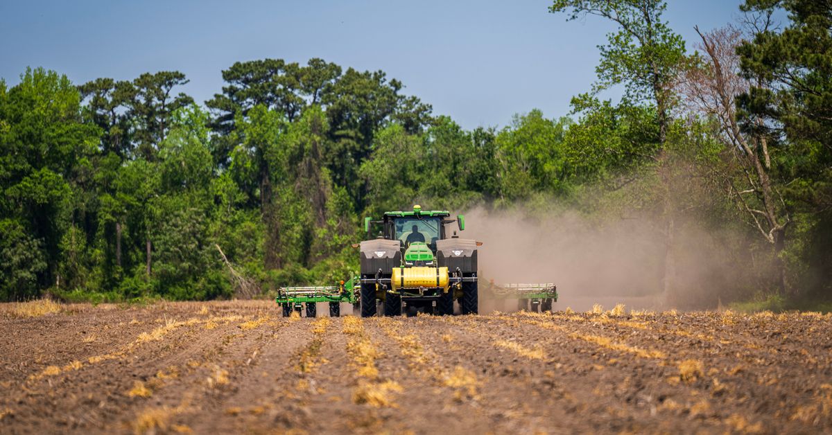 Tractor with rotavator preparing a field, rotavator guide for farmers